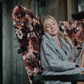 Woman dreaming in a large armchair in the HOCHKÖNIGIN SPA