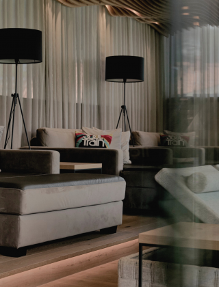 Close-up of the relaxation room with loungers, floor lamps, wooden design and curtains