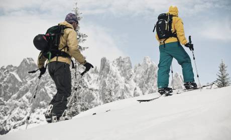 Group ski touring in the mountains with blue sky and snow in the background the mountains 