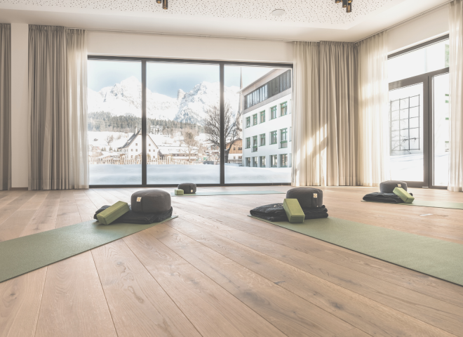 Fitness room with yoga mat in light colours