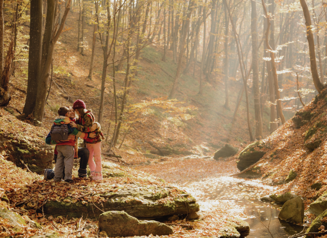 Children in the autumn forest by the stream